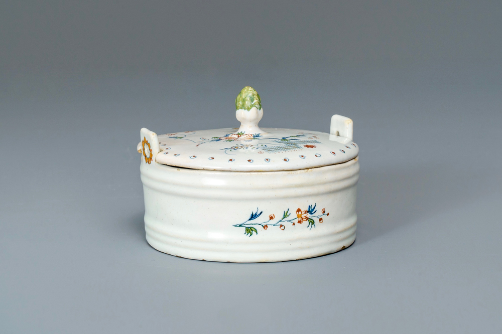 A polychrome Brussels faience '&agrave; la haie fleurie' butter tub and cover, 18th C.